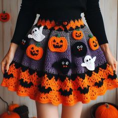 there is a woman wearing a skirt made out of crochet and pumpkins