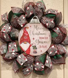 a christmas wreath hanging on the front door