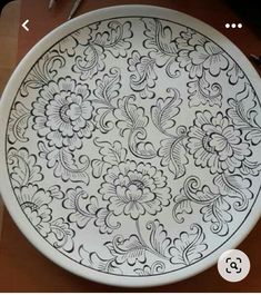 a black and white plate sitting on top of a table