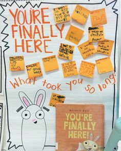 a bulletin board with sticky notes on it and an image of a bunny holding a book