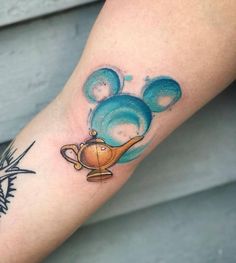 a tattoo on the arm of a person with a teapot and bubbles in it