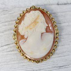 HERE ARE THE DETAILS YOU NEEDN6014Antique 14K Yellow Gold Carved Shell Cameo Brooch Pendant Pretty Lady LuxuryBEAUTIFUL LADY WITH HEADRESS, EARRINGS HAND CARVED SHELL CAMEO. FINEST DETAIL AMAZING BROOCH PIN WONDERFUL HIGHEST QUALITY. JUST PART OF MY MOST RECENT ESTATE FINDS! FOLLOW ME TO SEE THEM ALL! Metal Purity: Metal: 14K Yellow GoldMaterial: Carved Shell CameoForm: Brooch Pendant Pretty Lady LuxurySize :1 3/4 x 1 1/2"Age: AntiqueWeight (Grams): 11.8IT IS IN VERY FINE ESTATE CONDITION Luxury Intaglio Brooch For Formal Occasions, Exquisite Yellow Gold Brooch For Anniversary, Luxury Gold Brooches With Cabochon, Heirloom Cameo Brooch For Wedding, Heirloom Yellow Gold Brooches For Formal Events, Heirloom Cameo Brooches For Weddings, Heirloom Cameo Wedding Brooch, Luxury Oval Intaglio Brooches, Elegant Cameo Brooch In Yellow Gold