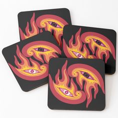 four coasters with flames and evil eyes on them