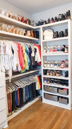 an organized closet with shoes and handbags on the shelves, drawers, and bins