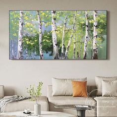 a living room with couches and paintings on the wall in it's center