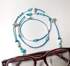 Miyuki Beaded Glasses Chain,Real Seashell Sunglasses Strap, Eye Glass Holder,Boho Hippie Mask Chain,Summer Jewelry,Beach Seed Beads Lanyards If you are tired of playing hide and seek with your glasses and masks, there is a colorful news for you! Thanks to our handmade eyeglass straps, which make it almost impossible to lose glasses and give life to boring frames, you can wear your glasses comfortably by hanging them on your neck when not wearing them. It completes your full BOHO chic look! You c Handmade White Glasses Chains For Summer, Adjustable White Glasses Chains For Beach, Adjustable White Glasses Chains For Festivals, Turquoise Glass Beach Jewelry, Beach Turquoise Glass Jewelry, Handmade White Glasses Chains For The Beach, Handmade White Glasses Chains For Beach, Blue Beaded Necklaces For Beach In Summer, White Glass Beaded Necklaces For The Beach