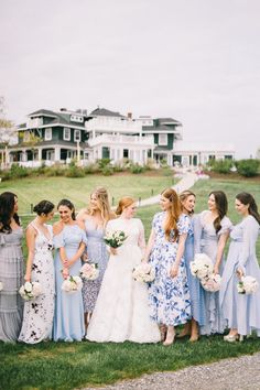 a group of women standing next to each other on top of a lush green field