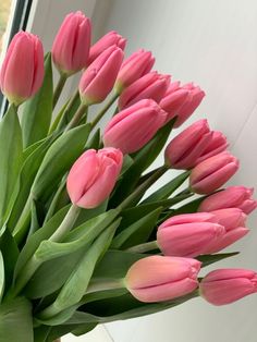 a bouquet of pink tulips in a vase