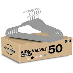 pack of 50 kids velvet hangers in a cardboard box with white and black labels