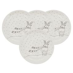 four white plates with reindeer designs on them