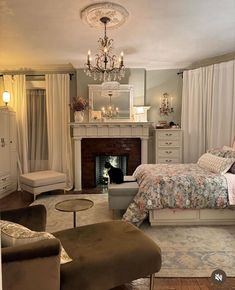 a bedroom with a bed, chair and fireplace in it's centerpieces