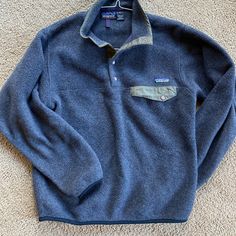 Vintage Patagonia In A Size Small. I’m Thinking It’s A Mens Small So Could Easily Fit A Ladies Medium. Good Used Condition. No Rips, Stains Or Anything Like That. The True Color Is More Charcoal Than The Blue. Olive Green Pocket And Trim Sweaters Vintage, Mens Sweaters, Vintage Patagonia, Patagonia Synchilla, Dream Clothes, Christmas List, Sweater Jacket, Shopping Cart, True Colors