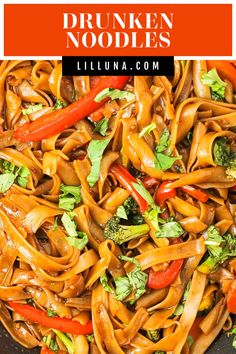 a pan filled with noodles, broccoli and peppers