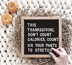 a hand holding a sign that says, this thanksgiving don't count calories count on your pants to stretch