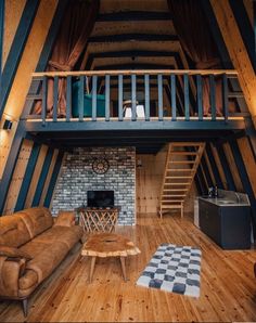 a loft with wood floors and wooden stairs