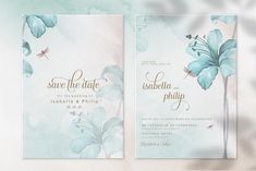 two wedding cards with watercolor flowers and dragonflys on them, one in blue and the other in pink