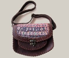 This leather bag is perfect for those who love the boho style and unique pieces. + Handcrafted from genuine leather and Banjara fabric, each bag is unique. The design features a vibrant combination of colors and patterns, which are inspired by traditional Banjara crafts in India. + The size is perfect for carrying everything you need, from your wallet and phone to your keys and cosmetics. Plus, the adjustable strap allows you to wear it as a crossbody bag or as a handbag. This bag is a true statement of style and quality. Each piece is carefully handcrafted with attention to detail meaning you get a unique and long lasting piece. + If you are looking for a unique leather bag that makes you feel good and elegant, then this Banjara Leather Bag is the perfect choice. + FEATURES: + Handmade le Bohemian Leather Bags With Leather Handles, Bohemian Leather Shoulder Bag With Leather Handles, Bohemian Leather Shoulder Bag For Daily Use, Soft Leather Shoulder Bag For Festivals, Bohemian Brown Satchel With Adjustable Strap, Bohemian Soft Leather Crossbody Bag, Bohemian Leather Hobo Bag In Crossbody Style, Bohemian Leather Crossbody Hobo Bag, Bohemian Crossbody Shoulder Bag With Leather Handles