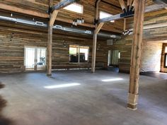 an empty room with wooden walls and beams