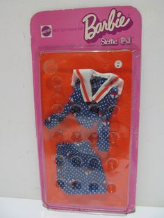 a package of clothes for barbie dolls with polka dots on the bottom, and an american flag in the middle