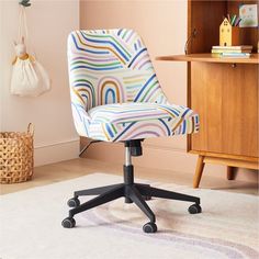 a colorful office chair sitting on top of a rug in front of a wooden cabinet