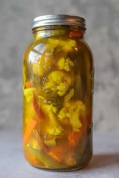 a jar filled with yellow and orange vegetables