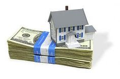 a house sitting on top of stacks of money next to a stack of bills and a blue ribbon