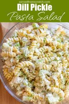 pasta salad with dill pickle dressing in a glass bowl on a wooden table