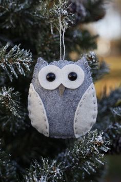 an owl ornament hanging from a tree