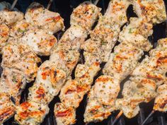 chicken skewers are being cooked on the grill