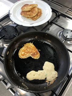 pancakes are being cooked in a skillet on the stove with other food items nearby