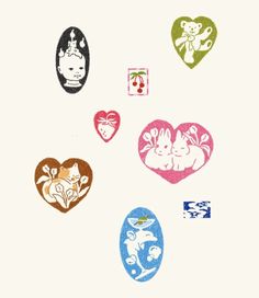 four heart shaped stickers with animals and hearts painted on them, all in different colors