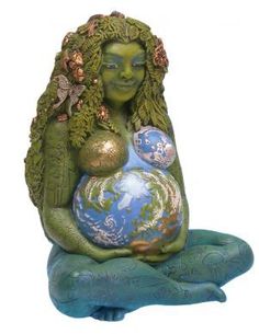 a statue of a woman holding a baby in her arms with the earth on it's back