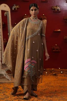 Gold kurta with floral patchwork, tassel, shell, zardozi, mirror embroidery. Paired with lurex pant and dupatta. - Aza Fashions Bohemian Dola Silk Set With Resham Embroidery, Traditional Wear With Dabka In Tissue Silk, Traditional Tissue Silk Dupatta With Dabka, Bohemian Dupatta With Dabka In Traditional Drape, Traditional Tissue Silk Wear With Dabka For Festivals, Bohemian Raw Silk Salwar Kameez With Traditional Drape, Bohemian Designer Dupatta With Dabka Work, Bohemian Designer Wear Dupatta With Dabka Details, Bohemian Dupatta With Dabka For Designer Wear