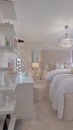 a bedroom with a bed, nightstands and chandelier