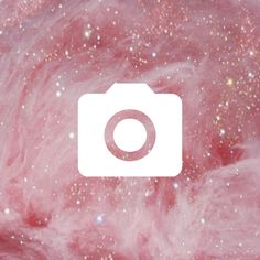 an image of a camera in the middle of pink and white dust with stars around it