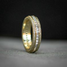 a gold ring with three rows of diamonds