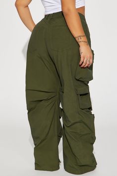 Available In Olive. Cargo Pant High Rise Button & Zip Closure Wide Leg Oversized Fit Non Stretch Distressed Wash Effect Windbreaker Fabric 65% Cotton 35% Nylon Imported | Talk It Up Oversized Distressed Washed Cargo Pant in Olive Green size XS by Fashion Nova High Waist Khaki Parachute Pants, Khaki High-waist Loose Fit Parachute Pants, Khaki High Waist Loosely Fitted Parachute Pants, Loosely Fitted High Waist Khaki Parachute Pants, Baggy Utility Bottoms With Elastic Waistband, Utility Baggy Bottoms With Elastic Waistband, Green Baggy Utility Pants, Baggy High Waist Green Cargo Pants, Green High Waist Baggy Cargo Pants