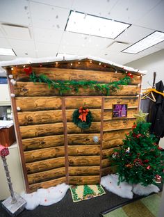 an office cubicle decorated for christmas with wreaths and decorations on the front door