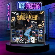 a display case with shoes on it in front of a neon sign that says laquata's sneaker ball