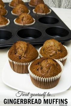 three muffins sitting on a plate next to a tray of cupcakes