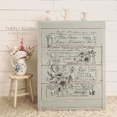 an old dresser has been painted blue and white with flowers in vases next to it