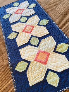 a quilted table runner on the floor