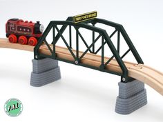 a toy train is going over a bridge