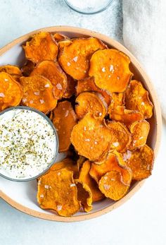 a bowl filled with potato chips and dip