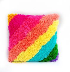 a multicolored pillow on a white background that looks like it is made out of yarn