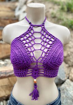 a mannequin wearing a purple crochet halter top