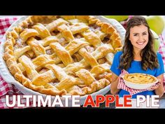 a woman holding a pie in front of an apple pie