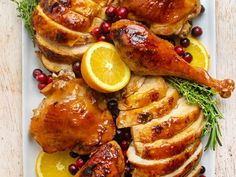 roasted turkey with cranberries and oranges on a white platter