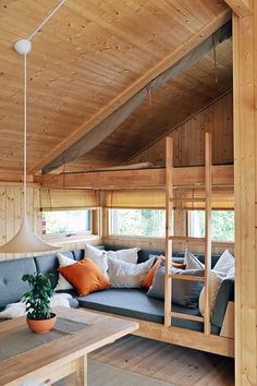 a living room filled with furniture and wooden walls