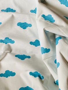 a bed with blue clouds printed on it